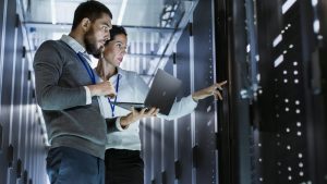 two computer technicians working to repair servers