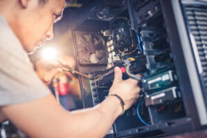 technician repairing computer tower